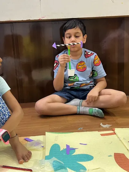 A boy tests his handmade spinning toy, learning about balance and aerodynamics. This simple craft is a great introduction to physics principles.