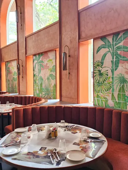 Another view of the dining area at The Koha, showing how the series of tropical tile murals creates a cohesive and sophisticated jungle-inspired theme throughout the restaurant.