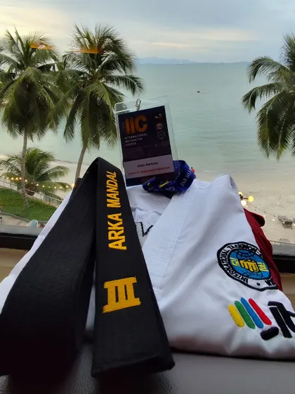 My Taekwon-Do dobok and black belt with my IIC credentials, overlooking the sea in Malaysia. This represents the journey and dedication to my art.