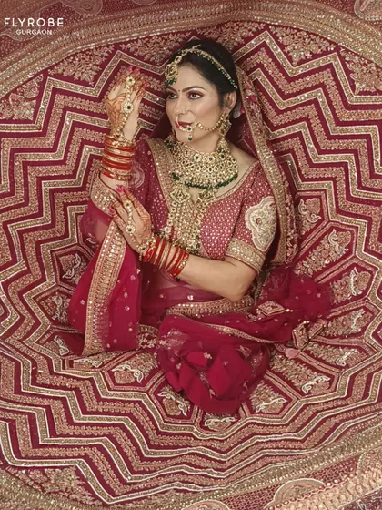 Another angle of this dramatic bridal portrait. The rich red and gold of the lehenga create a powerful and unforgettable image of bridal beauty.