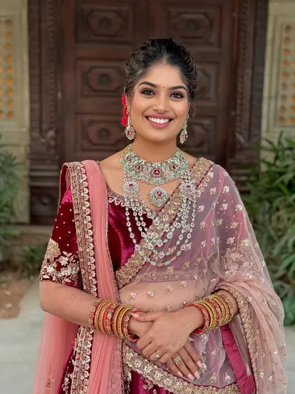 A beautiful portrait showcasing the royal velvet lehenga and the complementary makeup, featuring kohl-rimmed eyes and a radiant complexion.