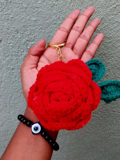 A beautiful red rose keychain. It's like a tiny bouquet you can carry with you everywhere.