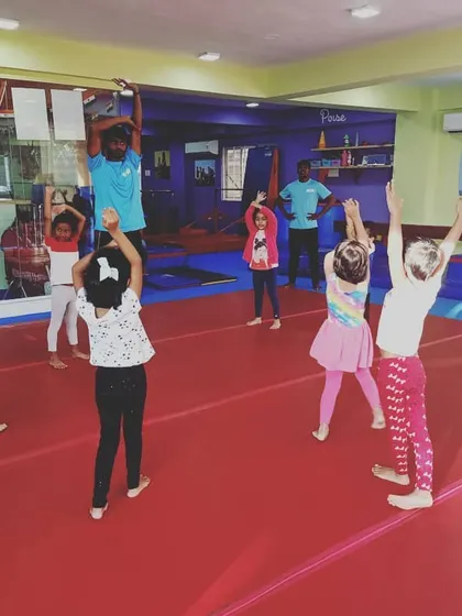 Our "Good Friends" class participating in the "Number Tumblers" theme. These images show the group learning advanced math and tumbling skills through warm-ups, stretches, and games.