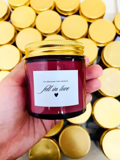 A simple and heartfelt wedding favor. This jar candle is customized with the phrase "all because two people fell in love."