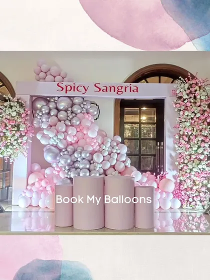 This "Spicy Sangria" themed decor is a perfect example of an elegant and fun setup for a social event. The combination of pink and silver balloons with beautiful floral towers creates a chic and inviting photo corner.