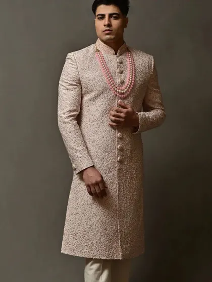 The full-length view of this sophisticated pink sherwani, a perfect choice for the modern groom.
