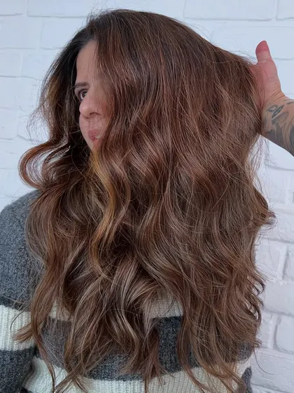 A rich, warm brown with subtle highlights, created with Redken color for a beautiful, dimensional look.
