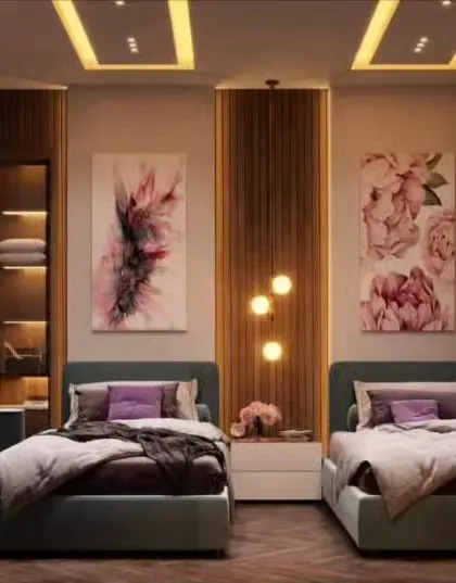 A stylish shared bedroom for two, featuring matching beds and a central study desk. The room uses a sophisticated color palette and elegant floral artwork, making it suitable for older children or teens.