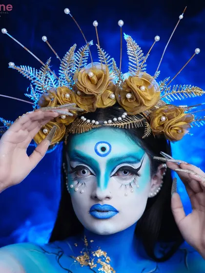 This shot captures the full effect of the fantasy makeup, from the dramatic eyes to the elaborate headpiece.