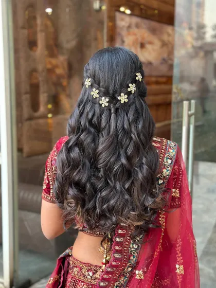 A close-up of the floral accessories in the half-updo.