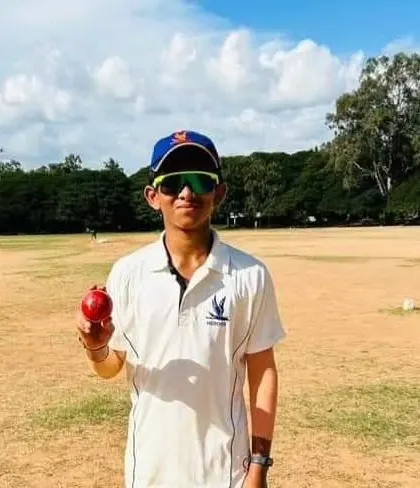 Pratyush G Shetty holding the ball after a great bowling performance, celebrating his selection for the KSCA U-14 Inter-Zonals.