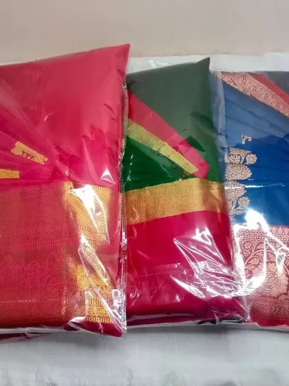 Three beautiful silk sarees, all pleated, ironed, and packed. They are now ready to be worn without any of the usual draping struggles.