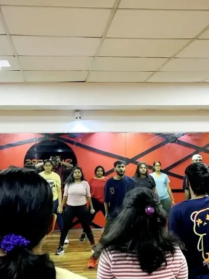 A candid shot from rehearsals for our grand finale. You can see the focus and determination as students listen to instructions from the choreographer.