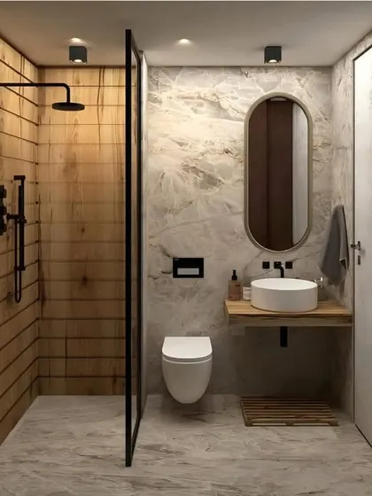 A simple and clean bathroom design with a walk-in shower. The combination of wood-look tiles in the shower area and marble-look tiles elsewhere creates a pleasing contrast of textures.