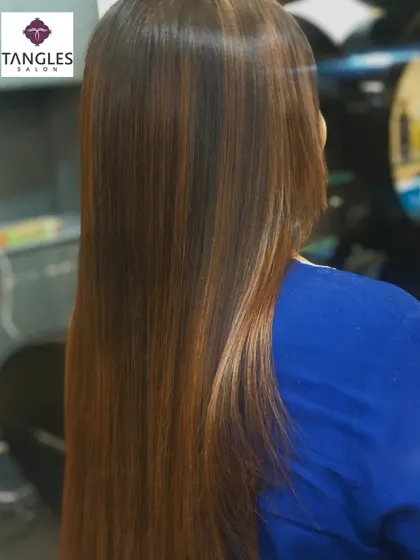 The final result of the gold chocolate balayage and Botox treatment. The hair is incredibly sleek and straight, showcasing the seamless blend of colors and the mirror-like shine that the treatment provides.