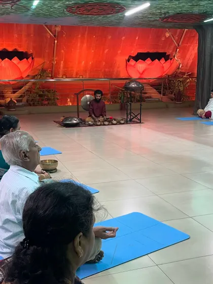 A group of participants, including senior citizens, preparing for a sound healing session. This practice is accessible to everyone, regardless of age or physical ability.