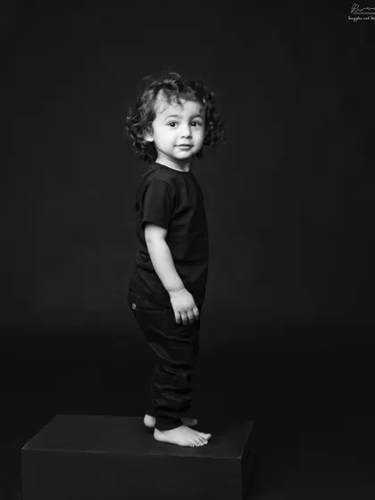 A simple, classic portrait of a child. The focus is entirely on his sweet face and curly hair, creating a timeless piece of art.