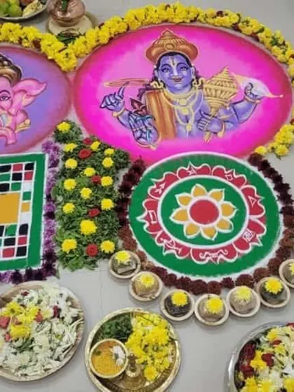 A colorful floor arrangement for a Gruhapravesh pooja, featuring rangolis of Lord Ganesha and Lord Vishnu. This setup is designed to bring blessings of prosperity and remove obstacles for the family entering their new home.
