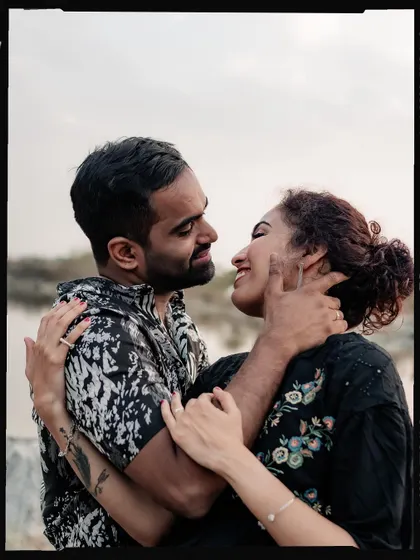 A candid and happy moment from a pre-wedding shoot, framed with a vintage film border.