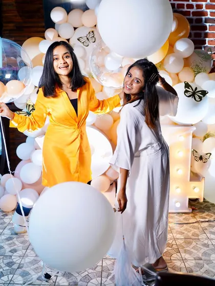 Happy faces and fun poses at this birthday celebration. The balloon wall with butterfly accents was a huge hit.