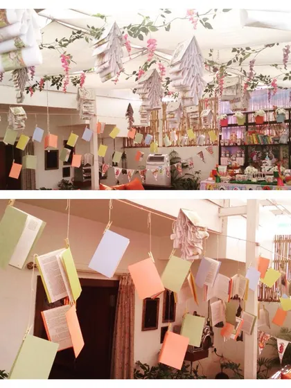 Hanging book decorations from the book-themed baby shower. I used open books to create mobiles and garlands, fully immersing the space in the literary theme.