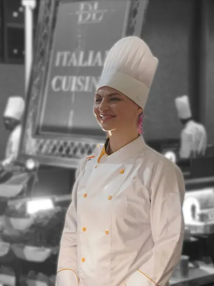 A portrait of one of our talented international chefs. Her confident smile reflects her passion for Italian cuisine and her pride in her craft.