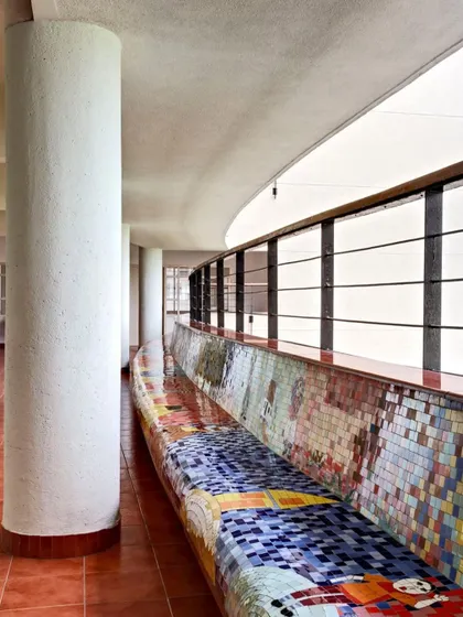 The long, curving mosaic bench at Save the Children, Mumbai. The vibrant colors and playful patterns bring warmth and energy to the space, making it an inviting and comfortable environment for children and families.