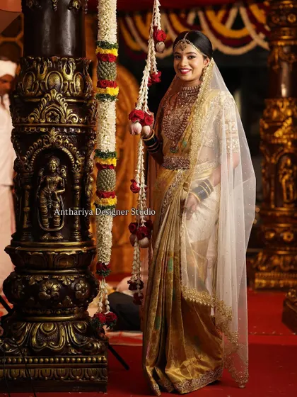The custom-designed veil adds a final touch of grandeur to Monisha's muhurtham look.