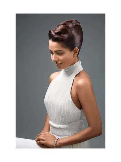 A seated version of the graceful profile shot. The lighting is perfectly controlled to create a smooth, flawless look, essential for beauty photography.