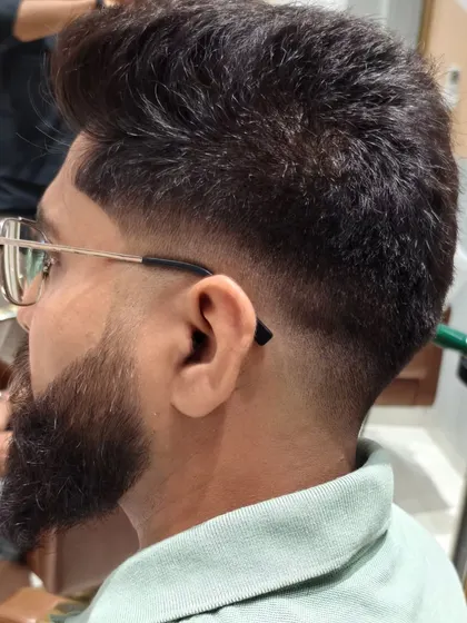 Creating the perfect look with a stylish haircut and a well-groomed beard.