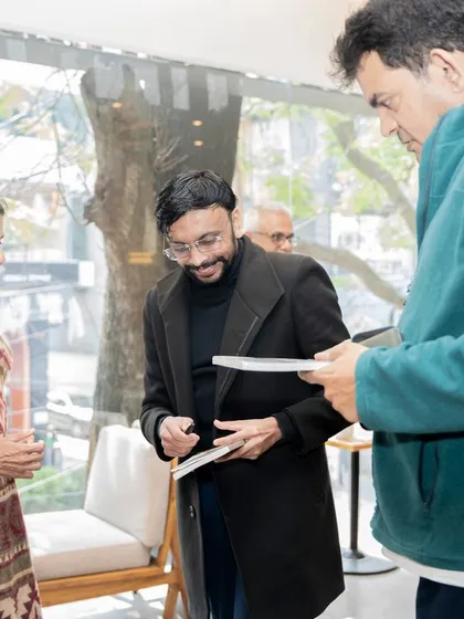Author Mini Menon in conversation with attendees during the book signing portion of her launch event.