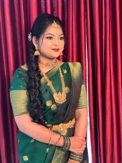 A side view of a client ready for her engagement, showcasing a simple side-parted hairstyle with a neat braid.