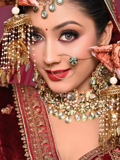 A close-up showing the kalire and the perfectly applied makeup. The red lip is bold and confident, a look many brides desire.