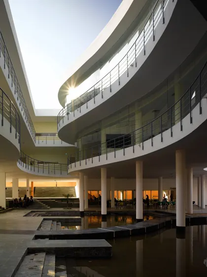 The Pearl Academy in Jaipur is a testament to our climate-responsive design approach. The central courtyard, inspired by traditional Indian step-wells or 'baolis', acts as a natural thermal regulator, using evaporative cooling from the water body to create a comfortable microclimate in the desert heat.