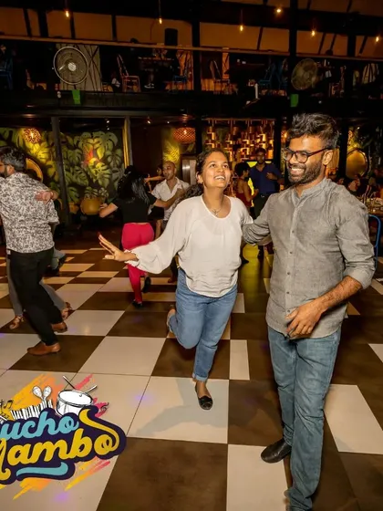 A candid shot of two dancers sharing a laugh. Our socials are just as much about making friends and building connections as they are about the dancing itself.