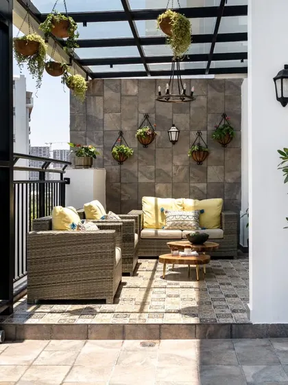An unused penthouse balcony transformed into a luxurious Spanish-inspired outdoor lounge. With a new glass canopy, patterned tiles, and comfortable seating, this space is now a perfect urban retreat for relaxing and entertaining.