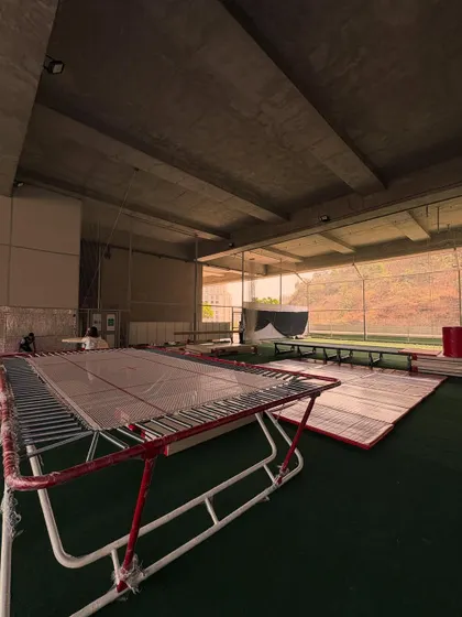 A view of the gymnastics setup, featuring trampolines and mats ready for action. This shows the professional equipment and spacious layout I provide for our gymnasts.