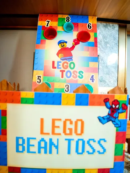 A close-up of the LEGO bean toss sign and game board, highlighting the themed details.