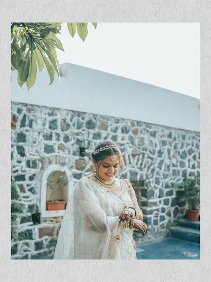 A candid moment of the bride checking her watch. It's a small, human moment that adds a touch of reality and charm to the series of portraits.