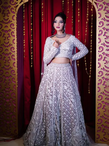 A full-length view of our pastel lavender lehenga with all-over white embroidery.