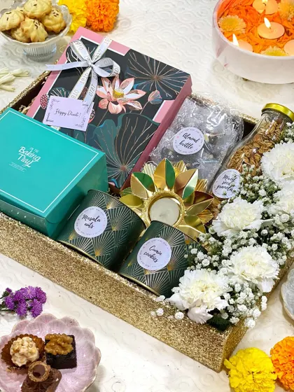 When it comes to festivals like Diwali, I love creating hampers that feel truly special. This one is a tray full of light and happiness, combining my handmade sweets and savories with fresh flowers and a beautiful decorative diya.
