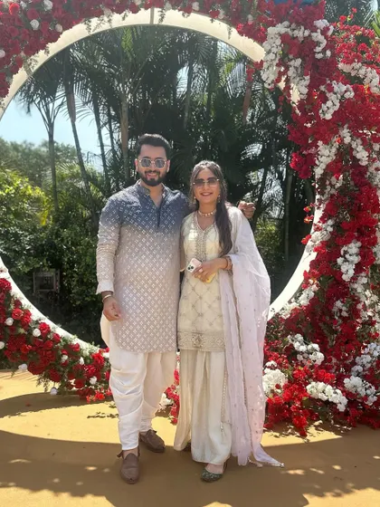 Posing with the bride and groom at their beautiful floral-decorated wedding arch. It's an honor to be a part of their special day from start to finish.