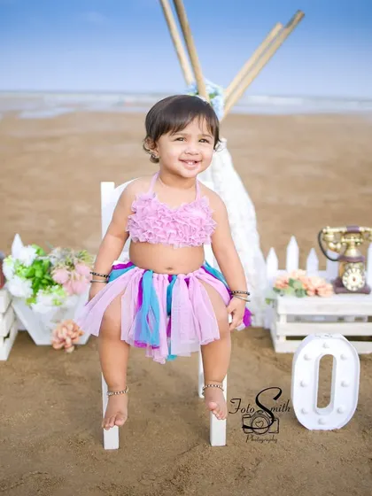 A wonderful beach-themed first birthday. The 'ONE' sign lit up on the sand adds a special touch to this outdoor celebration, capturing the free-spirited joy of a day by the sea.