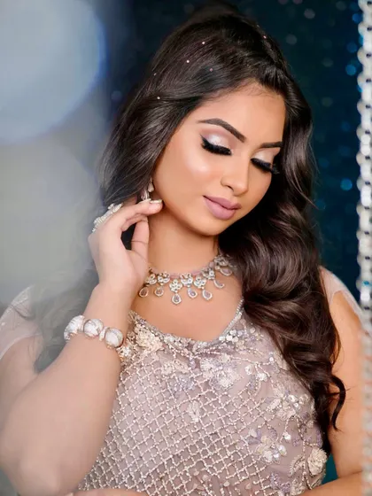 This image highlights a flawless complexion and shimmering eye makeup. It's a perfect example of the soft glam style that is highly requested for pre-wedding events like cocktail parties or receptions.