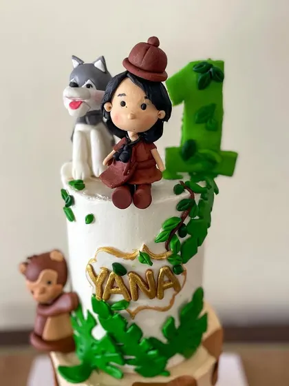 A close-up of the custom topper, designed to look like the birthday girl, Yana.