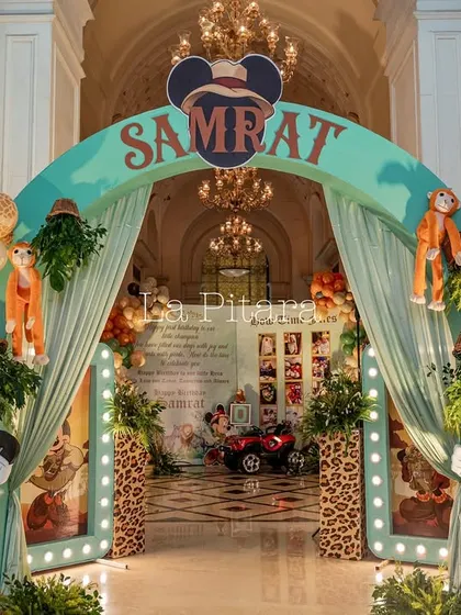 The magnificent main entrance arch to Samrat's jungle safari party, set in a grand, high-ceilinged hall.