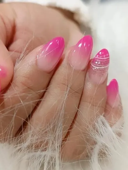 A bright pink ombre set with a creative twist, featuring a silver glitter accent nail with delicate white line art.