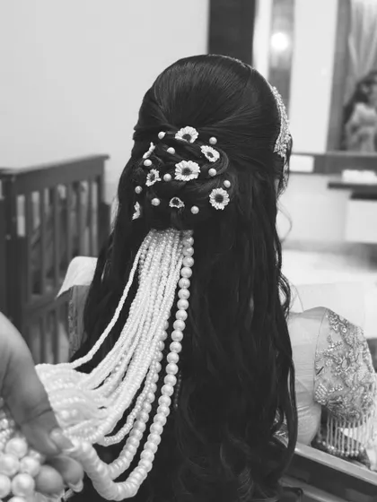 A black and white version of the hairstyle, emphasizing the texture and intricate details of the accessories.