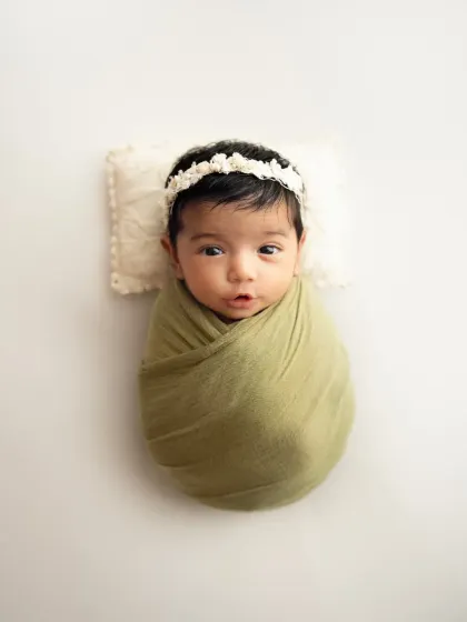 Those big, curious eyes. A simple, clean portrait of an awake newborn on a white background, showing off her beautiful features.