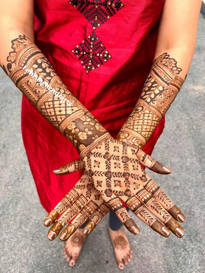 The back of the hands, featuring a complementary design with geometric patterns and floral bands.